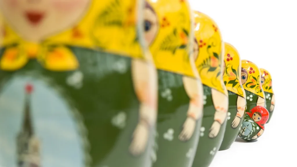 Line of russian dolls with one standing out - invisible search
