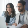 Two marketing professionals optimising content for AI search