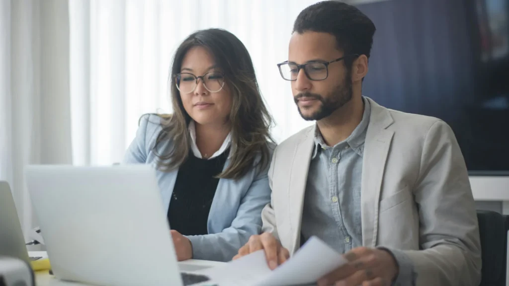 Two marketing professionals optimising content for AI search