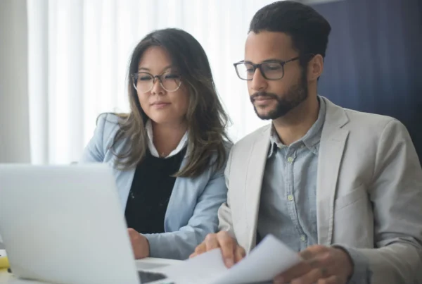 Two marketing professionals optimising content for AI search