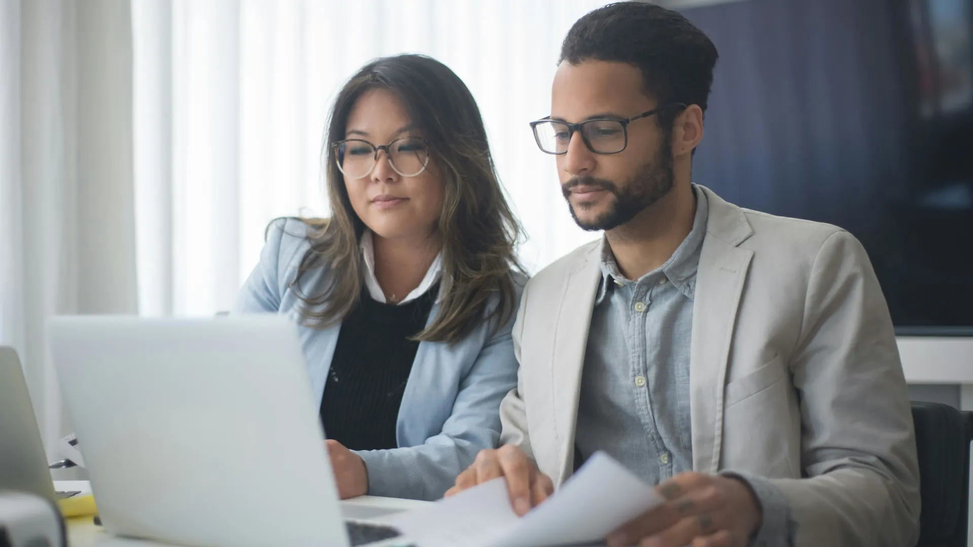 Two marketing professionals optimising content for AI search