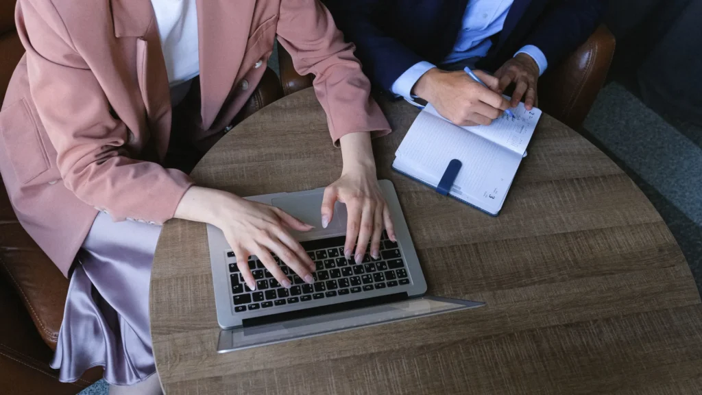 Two marketing professionals structuring content for AI search
